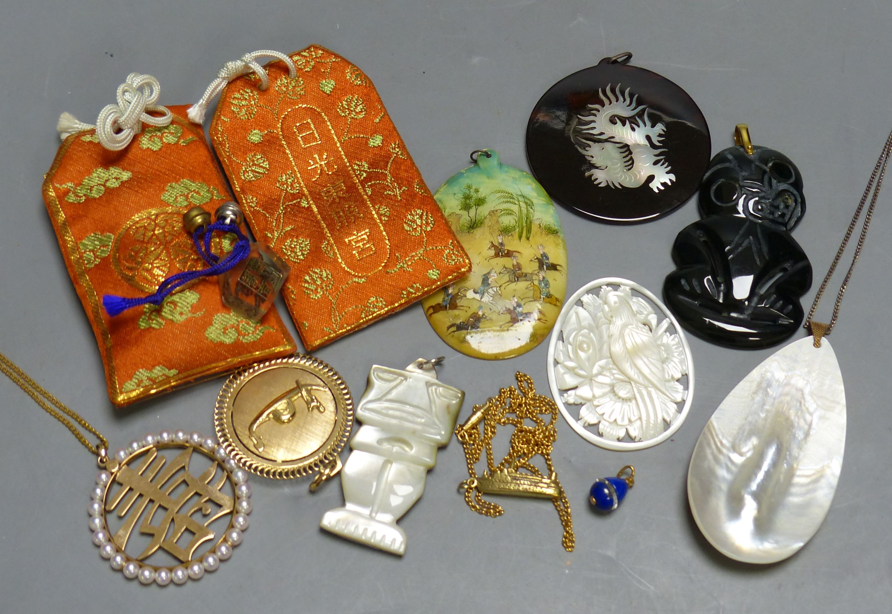 Miscellaneous decorative items, including a Mughal oval miniature on mother of pearl of polo players, a black painted hardstone tiki